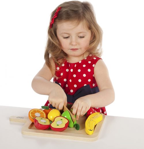 Child chopping fruit language development